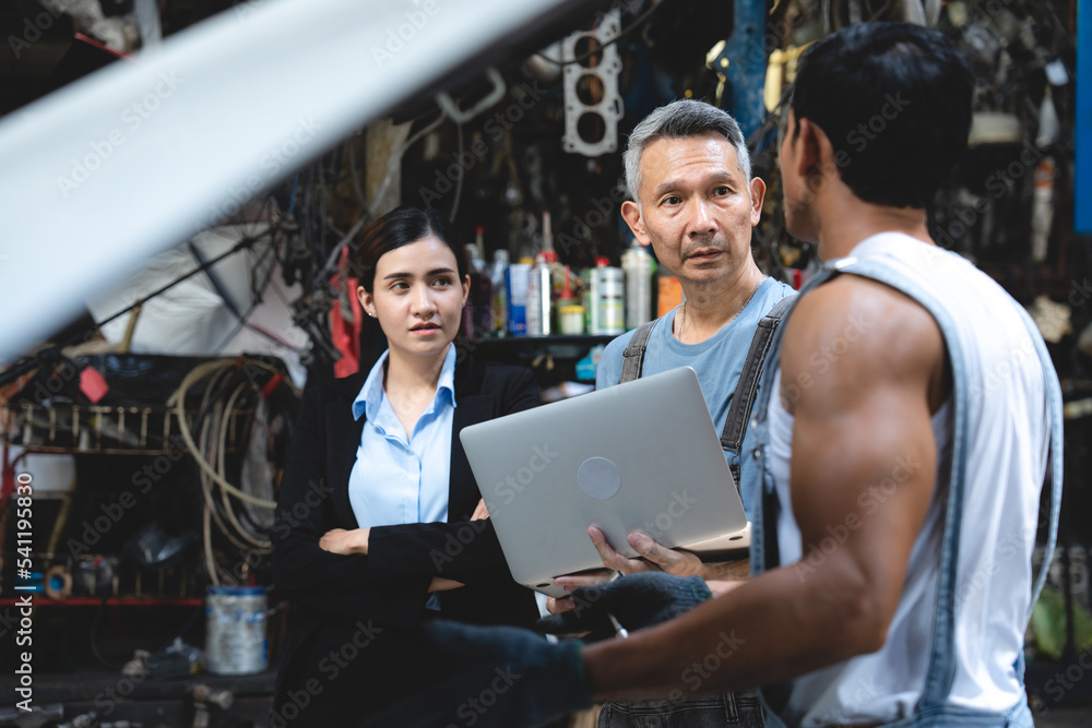 Obraz premium professional male technician mechanic man working to repair maintenance automobile at auto car garage service, talking with vehicle owner client about workshop job, automotive engine business shop