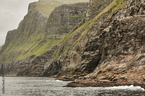 Picturesque green cliffs landscape and atlantic ocean. Faroe islands.