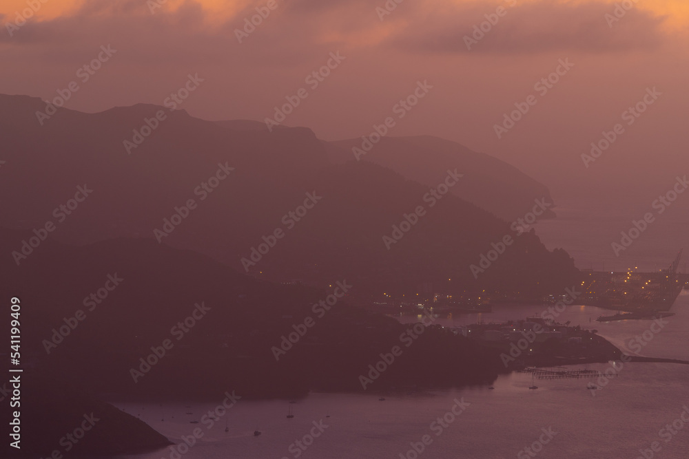 Fototapeta premium Foggy layer of mountains at sunrise time.