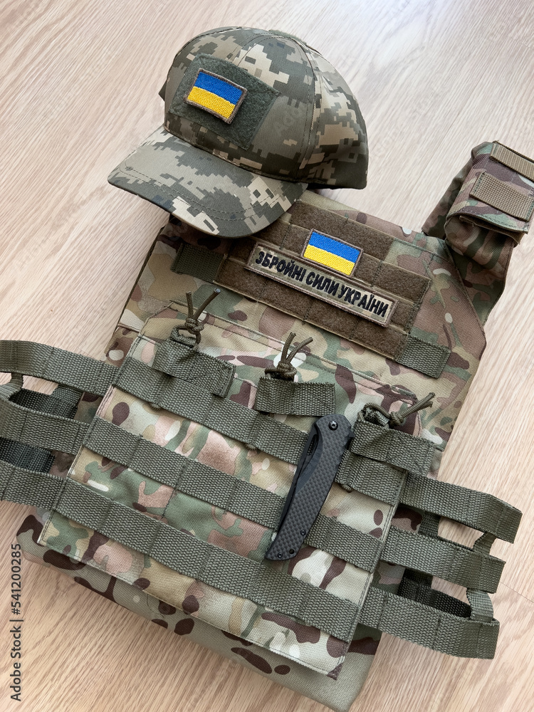 Ukrainian military bulletproof vest, camouflage cap and knife for the army.  Stock Photo