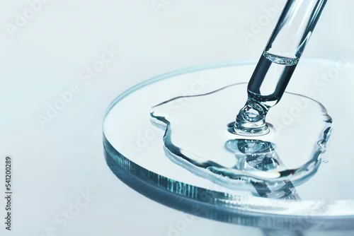 Obraz Pipette with sample of cosmetic product in petri dish on blue background, selective focus
