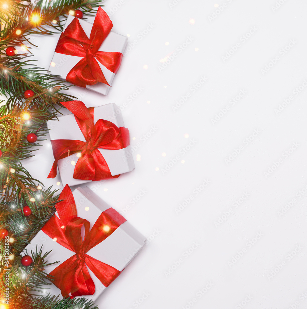 Spruce, fir branches, red berries, gift box on red background. Frame border. Christmas New Year composition background. Christmas lights. Space for text. Spruce, fir branches, red berries, gift box on red background. Frame border. Christmas New Year composition background. Christmas lights. Space for text.