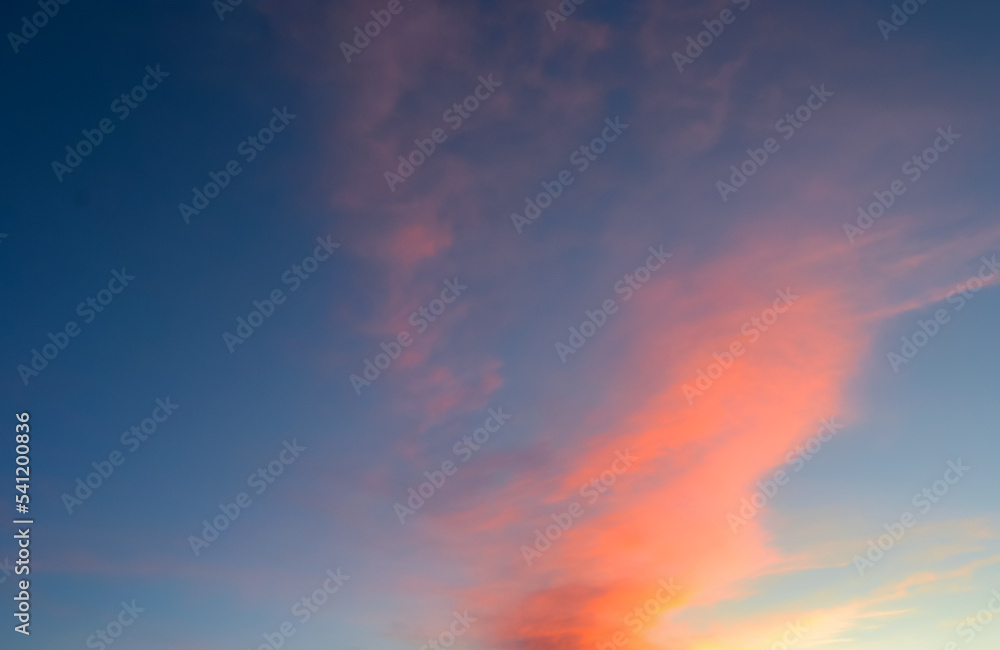 Colorful Sunset. Real amazing panoramic sunrise or sunset sky with gentle colorful clouds. Beautiful sunrise background. Blue, red, yellow colors. Natural backdrop of beautiful sky.