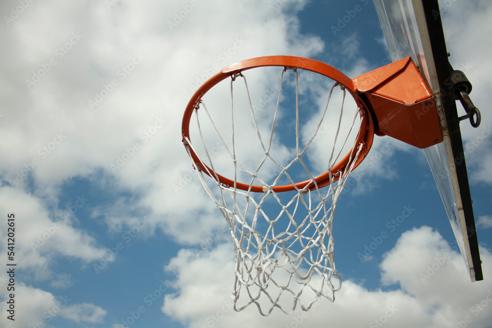 basketball hoop with its net under a blue sky basketball hoop with its net under a blue sky