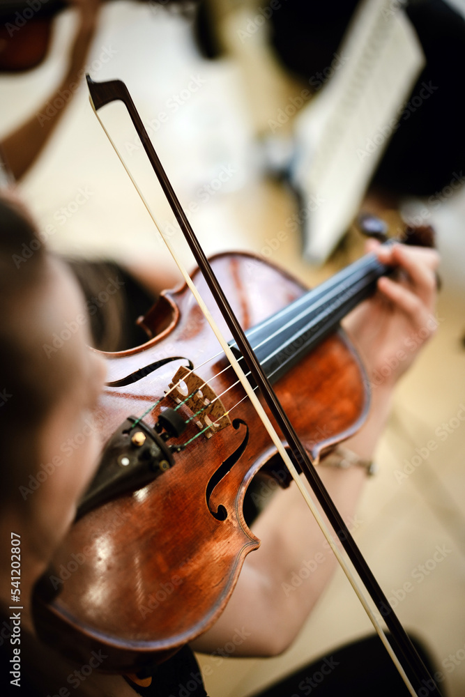 Unrecognizable woman playing the violin in public Unrecognizable woman playing the violin in public