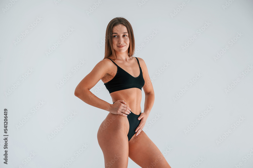 Black lingerie. Young woman in underwear is in the studio Black lingerie. Young woman in underwear is in the studio