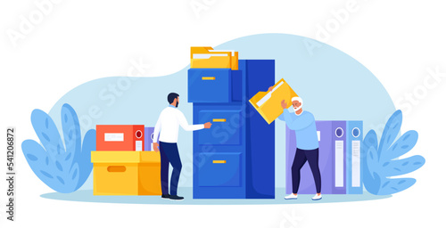 Document archiving and storage. Business people search files in archives. Support service, database. Men working with information, documents and statistics in analytical department. Folder in archive