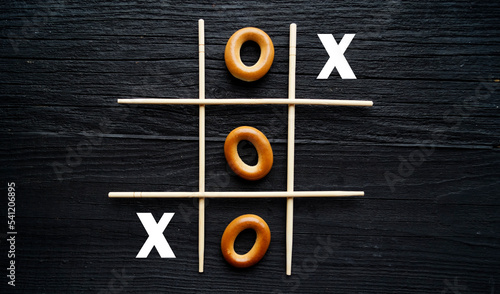 Tic-tac-toe from dryers on a black background top view