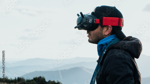 Person with FPV goggles flying a drone © Arai