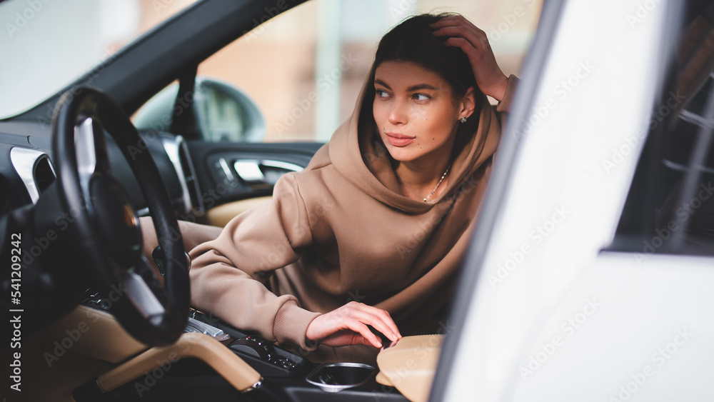 Attractive young girl driving a car. The girl gets out of the car Attractive young girl driving a car. The girl gets out of the car