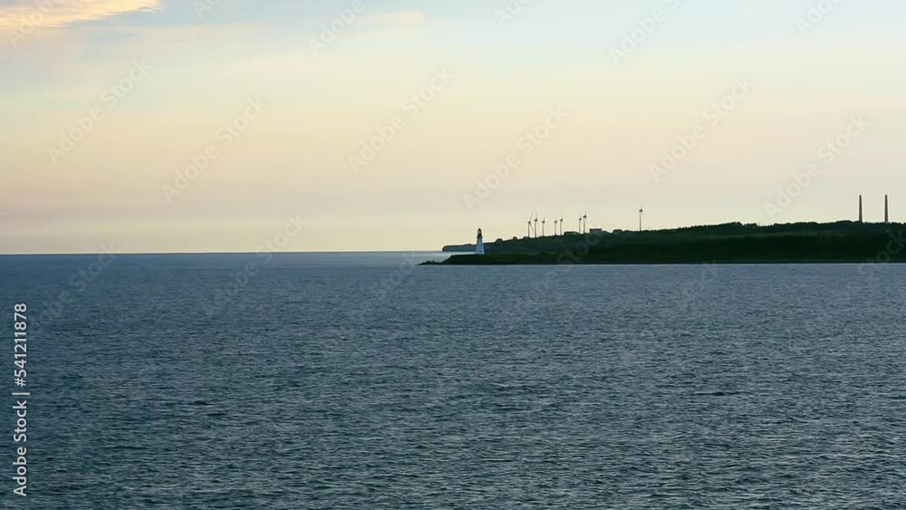 Coastal Lighthouse with windmills near Sydney, Nova Scotia off Cape Breton Island. Coastal Lighthouse with windmills near Sydney, Nova Scotia off Cape Breton Island.