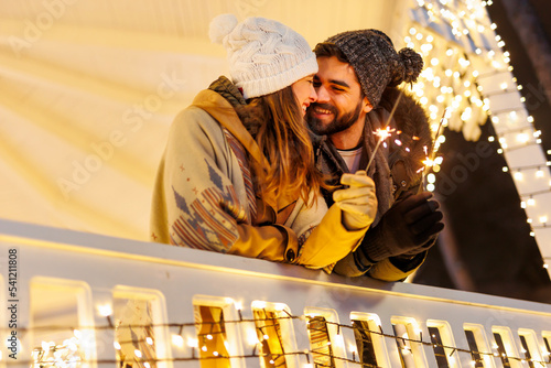 Couple holding sparklers at New Year midnight countdown