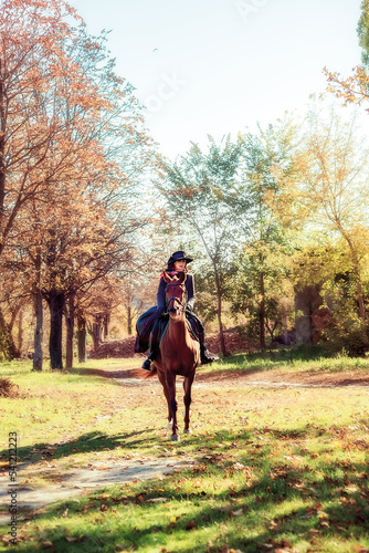 Girl in a hat on a horse