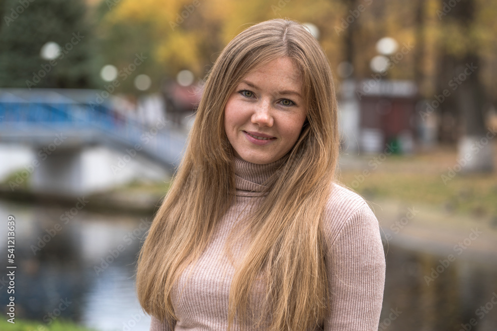 Happy beautiful red-haired woman posing in autumn park Happy beautiful red-haired woman posing in autumn park