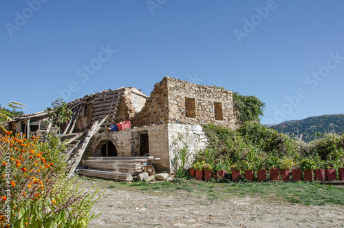 Destroyed and rebuilding  old stone house,on Lake Doxa in Ancient Feneos of Corinth. Greece photo