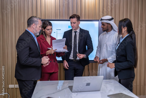 Group of business diversity people and middle east in office in the meeting room stand near big screen TV presentation contract agreement and signature close deal clap hands