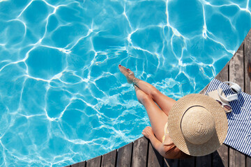 Woman on wooden deck near swimming pool