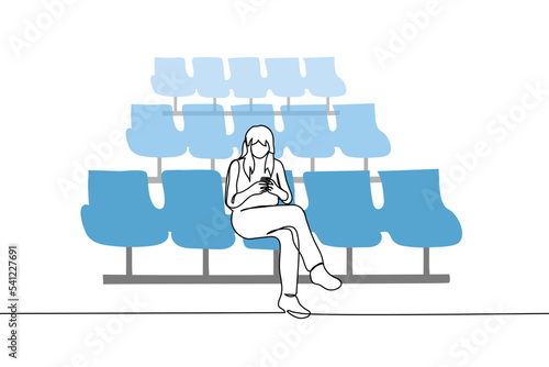 woman sitting in an empty waiting room digging into her phone - one line drawing vector. concept passenger of an airplane, trains waiting for their flight, late flight, being late for a flight