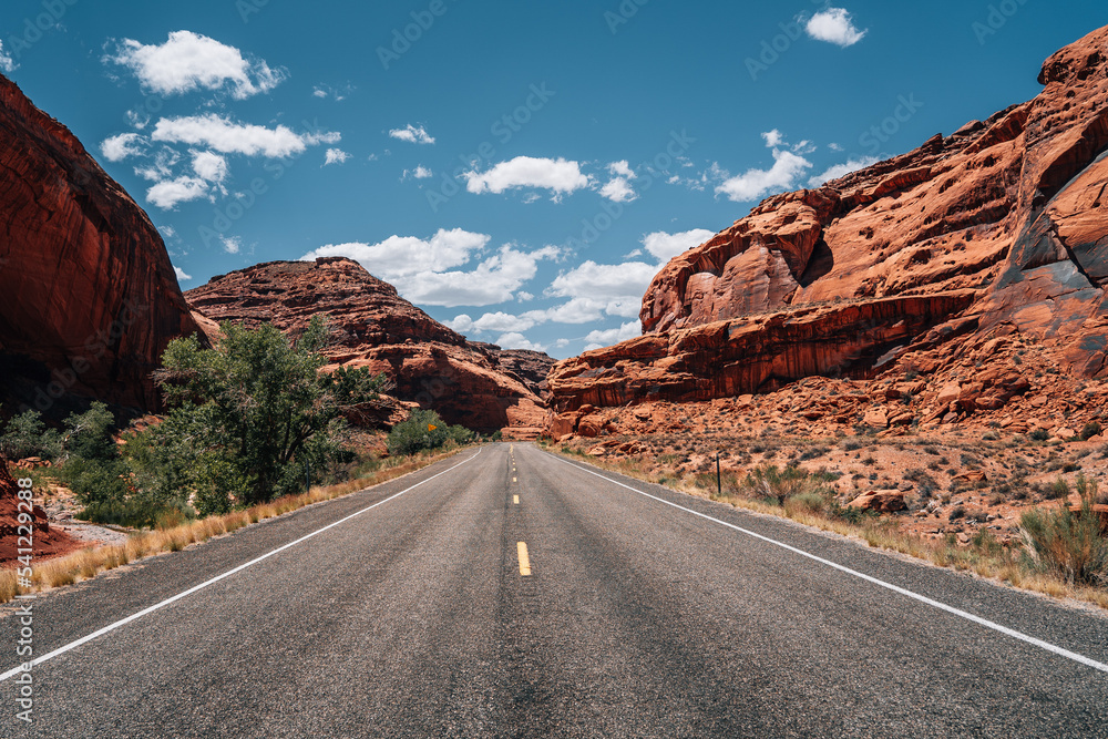Highway in the Desert of USA through Red Rocks on a cloudy Day