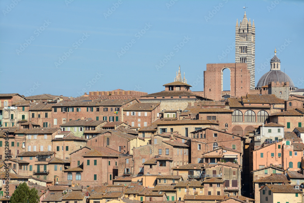 Panorama of Siena with the red houses, the cathedral in Italian Romanesque-Gothic style and the Torre del Mangia overlooking Piazza del Campo.