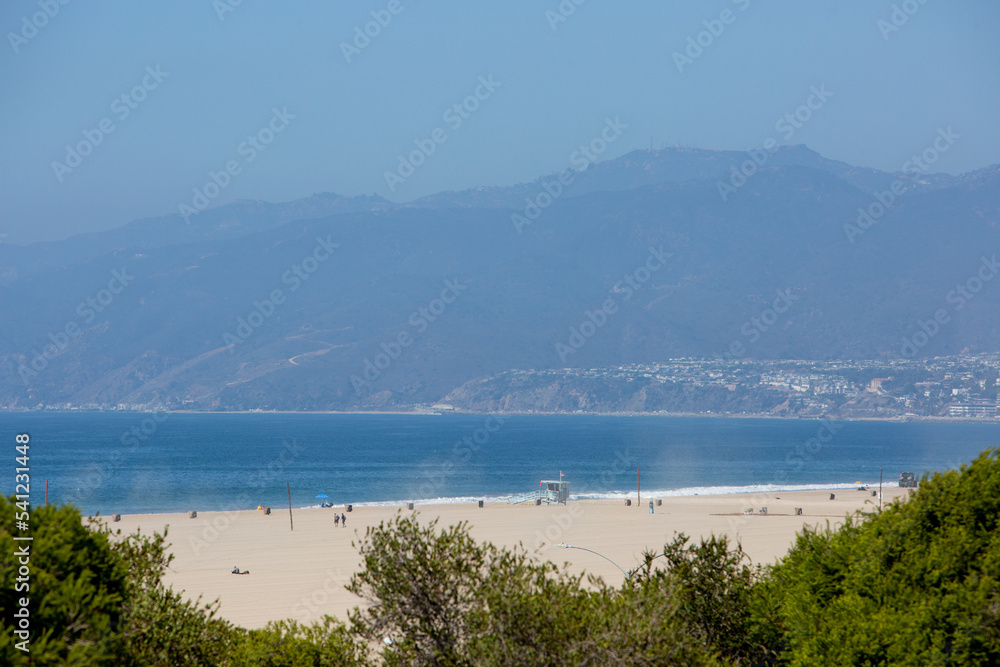 Malibu Beach View with Ocean, Village, Sand, and Mountain Zoomed by Telephoto Lens on Sunny Bright Day
