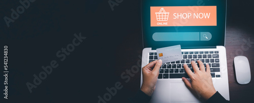 Hand using Laptop with model visa with Searching Browsing Internet Data Information with blank search bar. man's hands are using smartphone and keyboard,Online shopping, e-commerce.