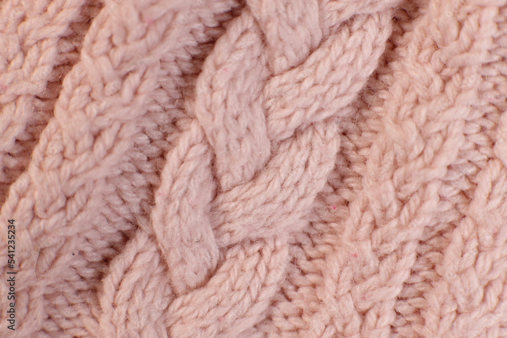 texture hand-knitted or machine knitting pattern braid. fabric background close-up texture hand-knitted or machine knitting pattern braid. fabric background close-up