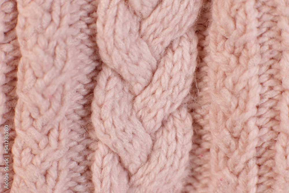 texture hand-knitted or machine knitting pattern braid. fabric background close-up texture hand-knitted or machine knitting pattern braid. fabric background close-up