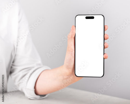 Hand holding iphon 14 phone, screen mockup, blank white display of new iphone. High quality photo photo