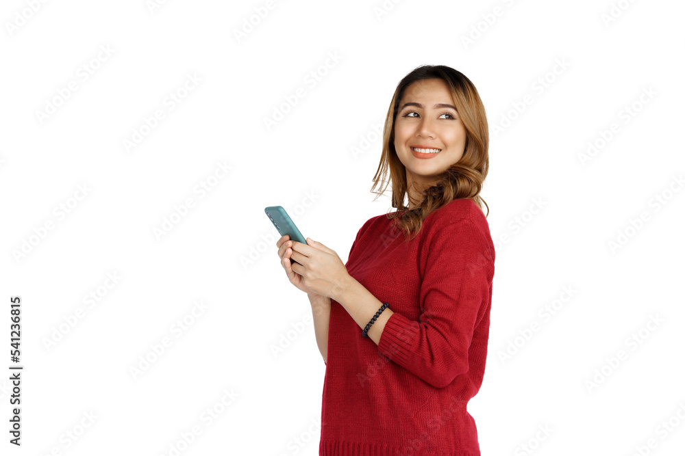 Using mobile, Excited young brunette pretty asian woman isolated on white background, red sweater. Using mobile, Excited young brunette pretty asian woman isolated on white background, red sweater.
