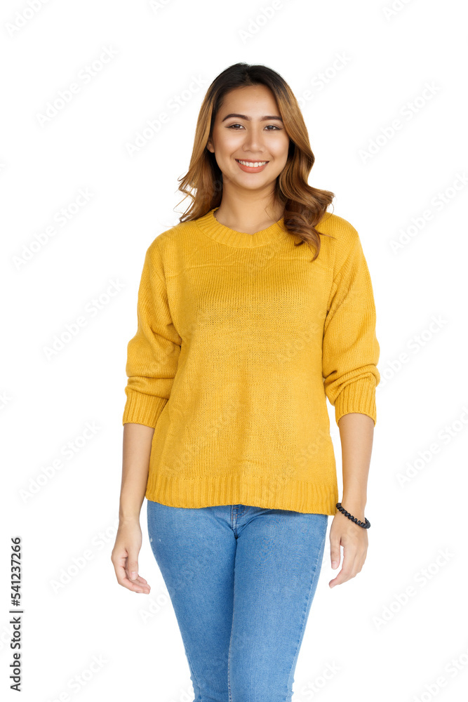 Obraz premium Attractive positive young asian brunette woman in yellow sweater on white background.
