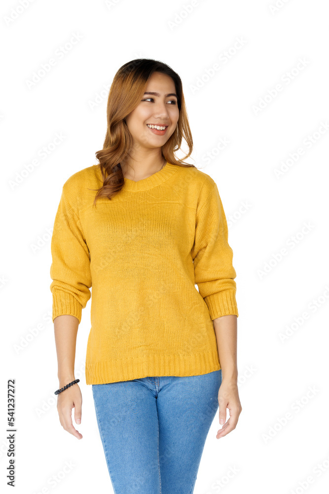 Obraz premium Attractive positive young asian brunette woman in yellow sweater on white background.