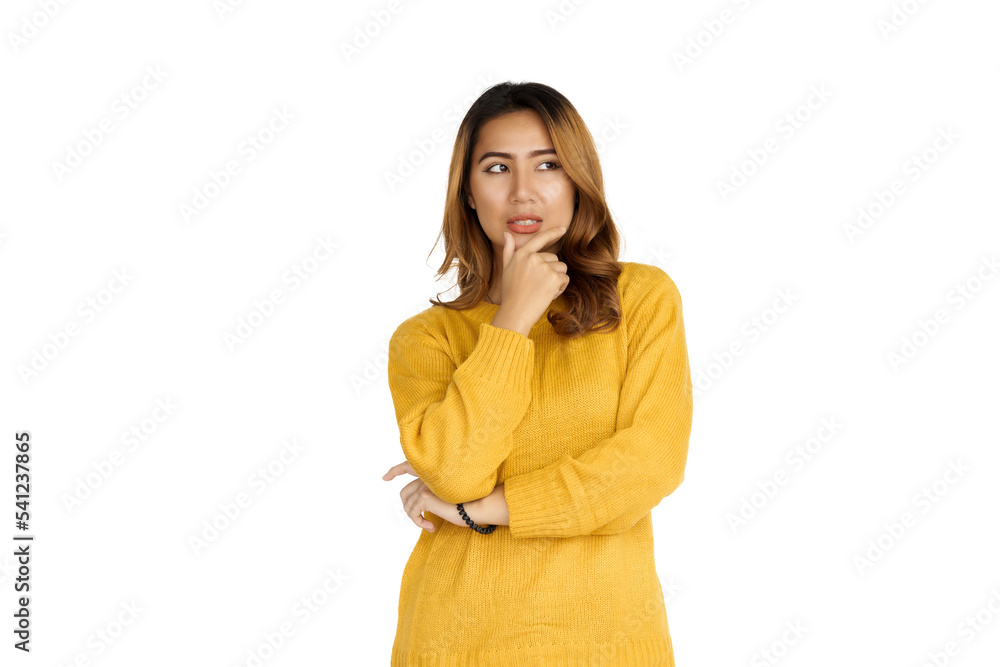 Attractive positive young asian brunette woman in yellow sweater on white background. Thinking serious Attractive positive young asian brunette woman in yellow sweater on white background. Thinking serious