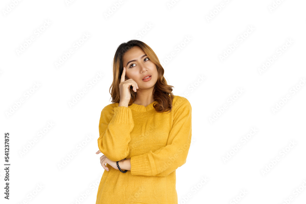Attractive positive young asian brunette woman in yellow sweater on white background. Thinking serious Attractive positive young asian brunette woman in yellow sweater on white background. Thinking serious