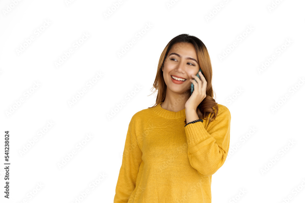 Using mobile, Attractive positive young asian brunette woman in yellow sweater on white background. Call a phone. Using mobile, Attractive positive young asian brunette woman in yellow sweater on white background. Call a phone.