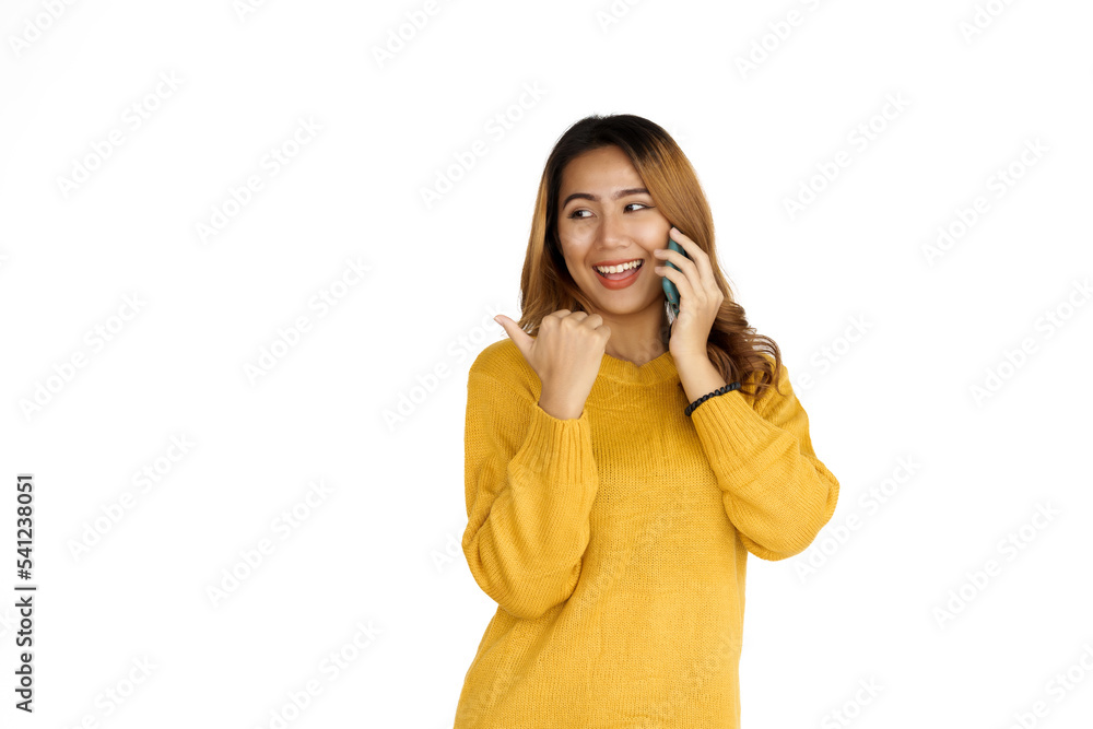 Using mobile, Attractive positive young asian brunette woman in yellow sweater on white background. Call a phone. Using mobile, Attractive positive young asian brunette woman in yellow sweater on white background. Call a phone.