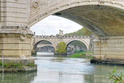 The Saint Angelo bridge spanning the Tiber river in Rome Italy as seen on a fall day. © phillips