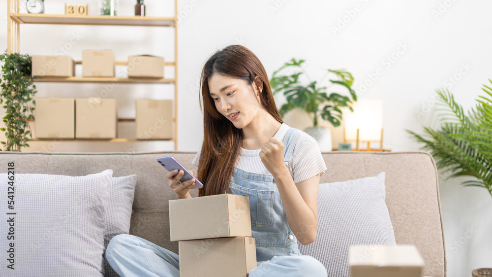 Woman was happy after receiving an order from an online customer, New business style for people working at home and owning businesses, Online shopping SME entrepreneur, Packing box, Sell online. Woman was happy after receiving an order from an online customer, New business style for people working at home and owning businesses, Online shopping SME entrepreneur, Packing box, Sell online.