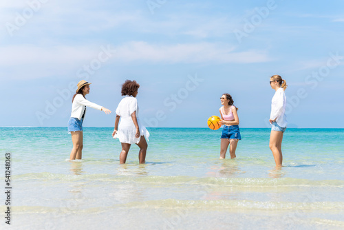 Photo of a group of girls of different ethnicities running and having fun together at the beach. on a fresh day