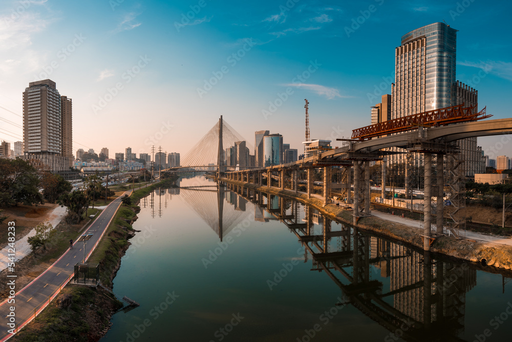 View of Pinheiros River With Modern Buildings Alongside and Famous Octavio Frias de Oliveira Bridge in Sao Paulo City View of Pinheiros River With Modern Buildings Alongside and Famous Octavio Frias de Oliveira Bridge in Sao Paulo City