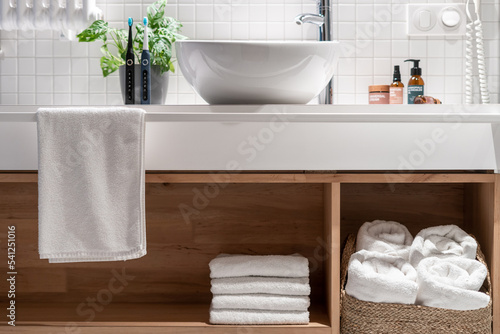 Fotografija Wooden countertop with shelf for storage fresh and white terry towels
