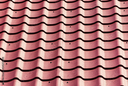 Close up to wavy red roof tiles pattern. Industrial pattern or background