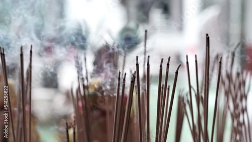 Incense burning with dragon figure in ancient asian temple Taiwan. place of worship, incense sticks burning with smoke and a praying man in buddhist temple, Burning incense sticks with smoke.