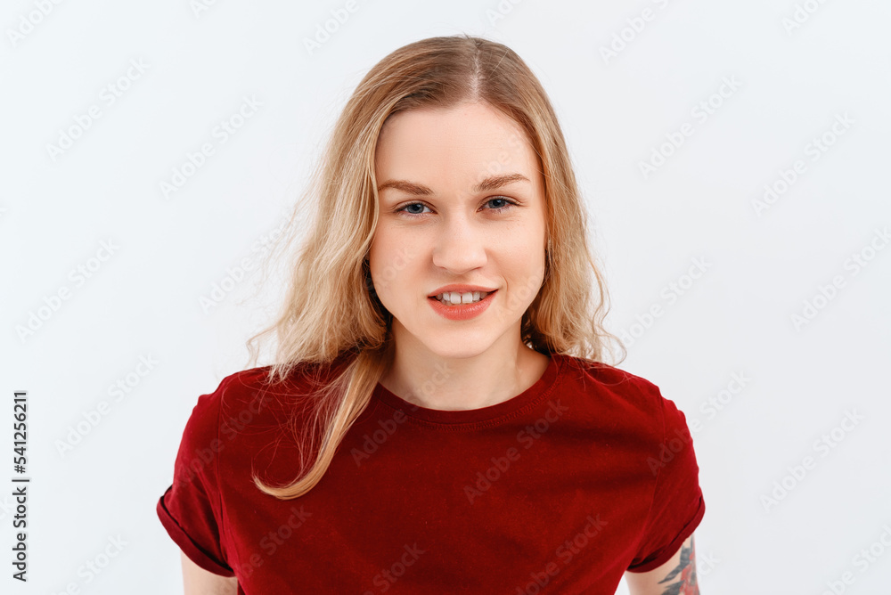 Young emotional woman. Close up portrait of young blonde woman 20s, wearing casual red t shirt. Indoor studio shot on white background. Human emotions, facial expression concept Young emotional woman. Close up portrait of young blonde woman 20s, wearing casual red t shirt. Indoor studio shot on white background. Human emotions, facial expression concept