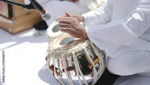 Tabla Yoga Music. Close-up of hands of an Indian man playing a paired tabla drum. 