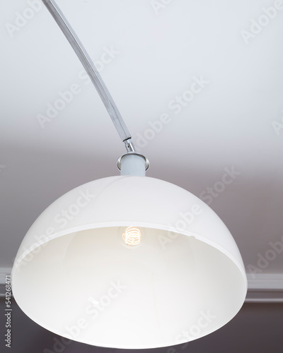 Vintage white plastic shade from a 1970s arc lamp. Mid-century modern lighting. Closeup detail. 
