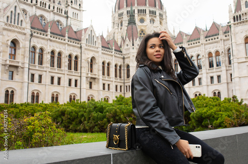 Photography Happy black woman student enjoying great view of the Parliament building in Budapest city, travel in Europe concept