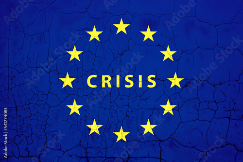 Crisis in the European Union. The word CRISIS on cracked EU flag.