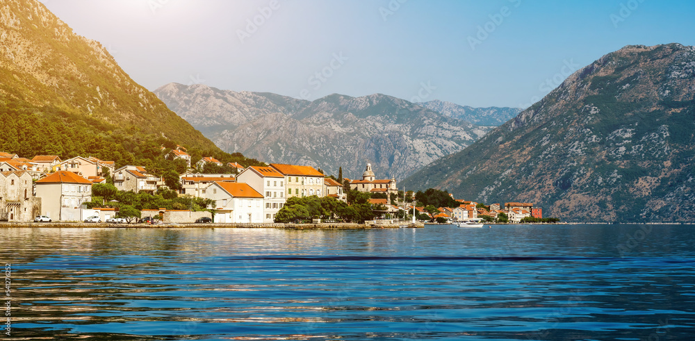Beautiful city in Adriatic sea in Montenegro with mountain view in summer sunny dy. Scenic town with nature landscapes