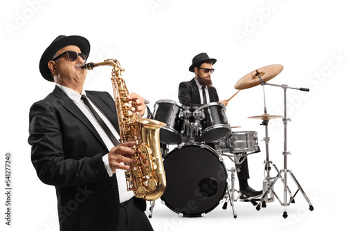 Man playing a saxophone and a drummer performing